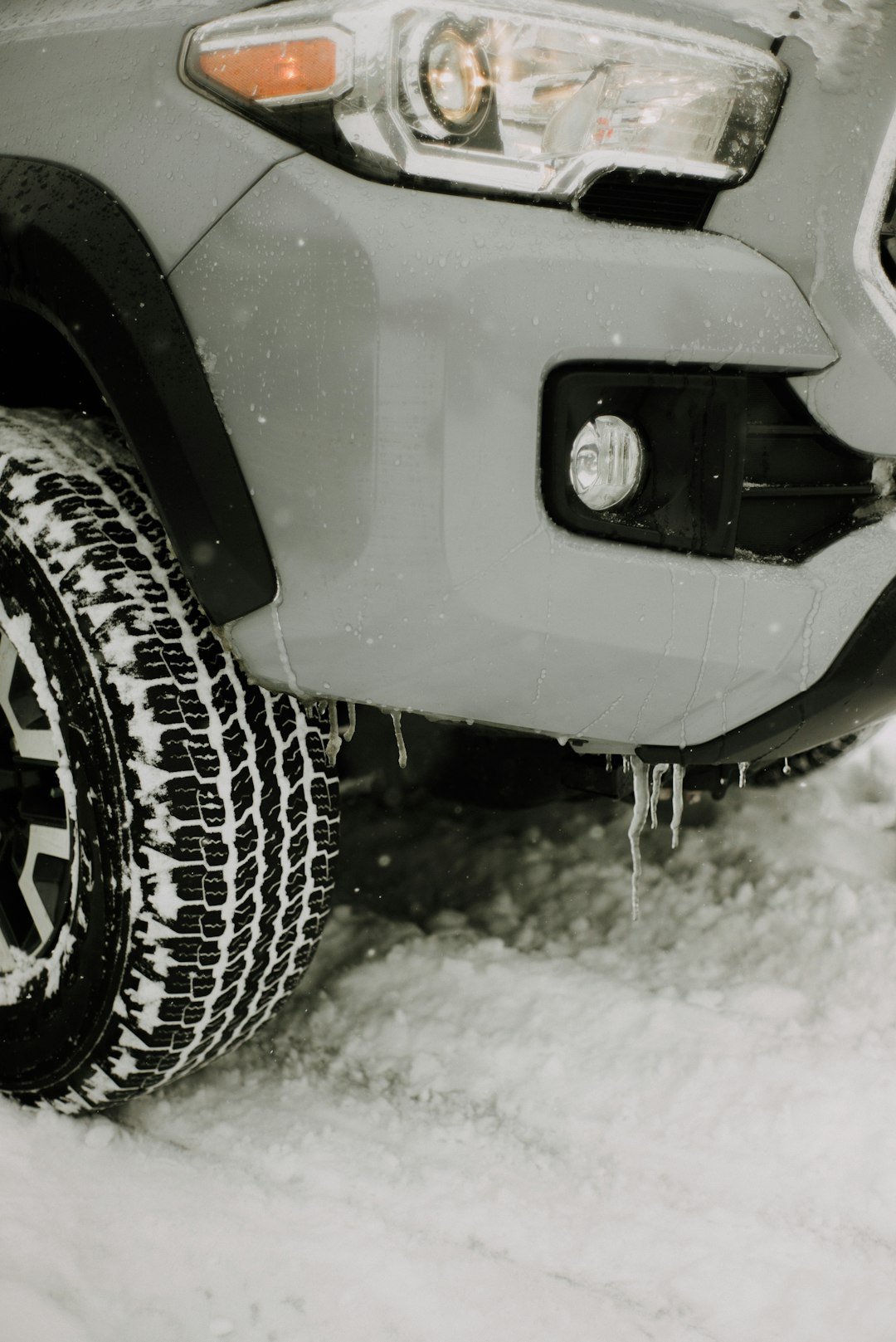 Car tire in the snow, winter roadside