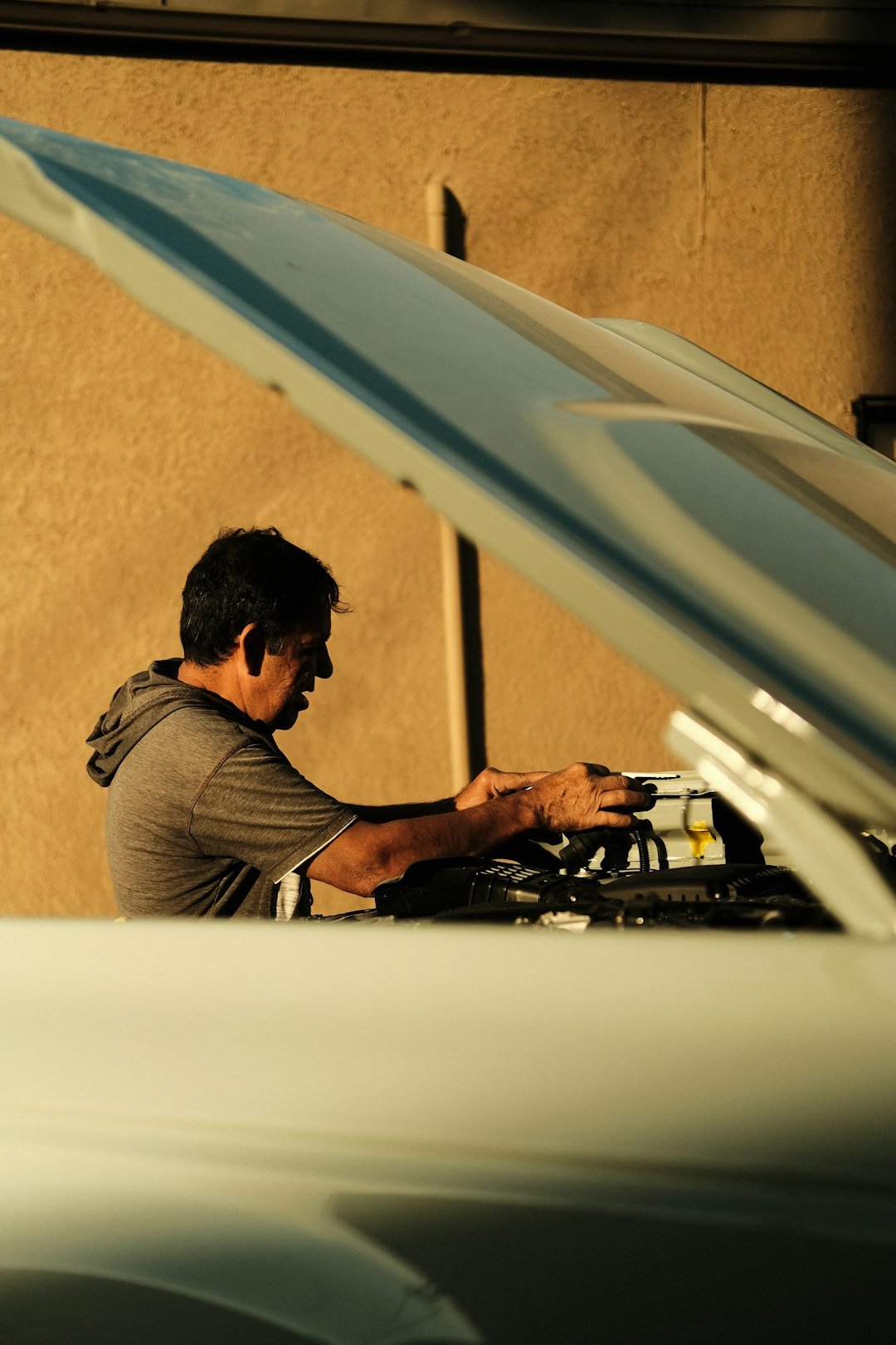 Mechanic working under the hood of a car